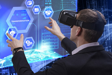 Business, Technology, Internet and network concept. Young businessman working on a virtual screen of the future and sees the inscription: Transformation