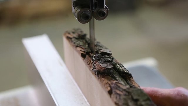 Man Uses An Electric Saw To Cut Wooden Planks