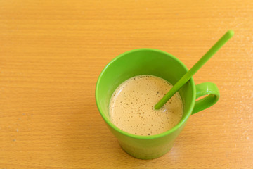 Cup of coffee on wooden back ground