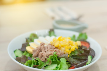 Tuna salad with corn egg on table.