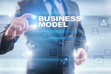 Businessman selecting business model on virtual screen.