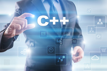 Businessman selecting c++ on virtual screen.