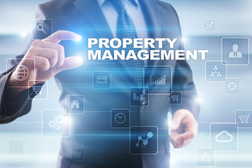 Businessman selecting property management on virtual screen.