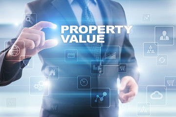 Businessman selecting property value on virtual screen.