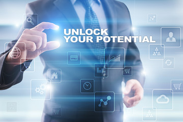 Businessman selecting unlock your potential on virtual screen.