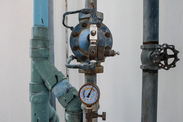 manometer, measuring gas pressure. Pipes and valves at industrial plant.