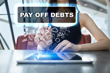 Woman using tablet pc and selecting pay off debts.