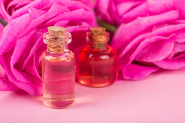 Pink roses and oil on a bright background