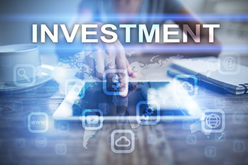Woman using tablet pc, pressing on virtual screen and selecting investment.