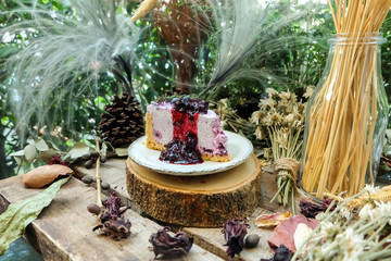 blueberry cheesecake on timber and decorated table, Flower ornamental,Dry flowers,Grass flower,Pine cone