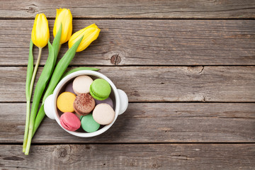 Colorful macaroons and yellow tulips