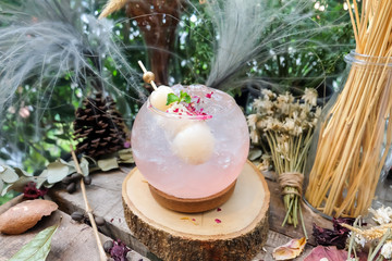 Lychee juice on timber and decorated table, Flower ornamental,Dry flowers,Grass flower,Pine cone