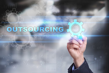 Businessman is drawing on virtual screen. outsourcing concept.