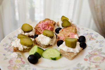 small sandwiches with cheese and cucumber