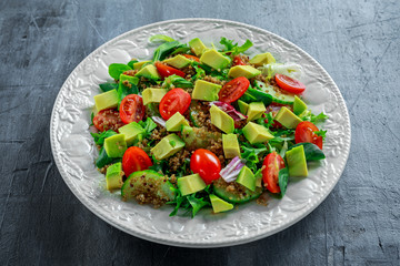 Quinoa tabbouleh salad with avocado, tomatoes, cucumber, green onion. Concept healthy food.