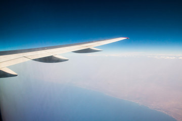 Wing of aeroplane flying in the sky