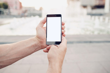 Hands holding blank screen smartphone with clipping path for screen