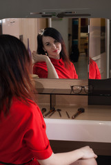 Woman in short red dress sitting