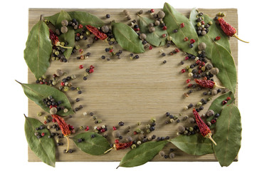 Kitchen cutting board, scattered spices in the form of a frame.