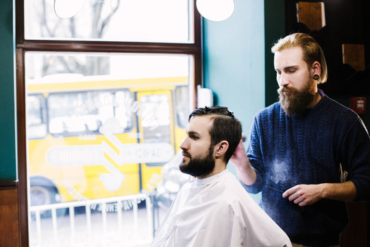 Barber covers man's hair with powder