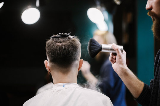 Barber covers man's head with powder