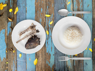 Poor meal of rice and fish bones.