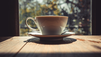 Hot coffee cup on wooden table with a clearly mirror view background.