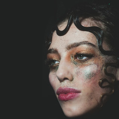 Pretty fashion girl with holiday glitter makeup