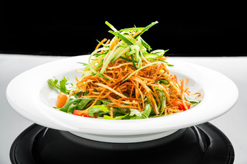 Vegetarian salad with fried potato chips and arugula on a plate