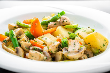 Hot salad with fried potatoes, mushrooms and asparagus