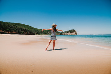 Woman dancing in an Australian beach paradise.