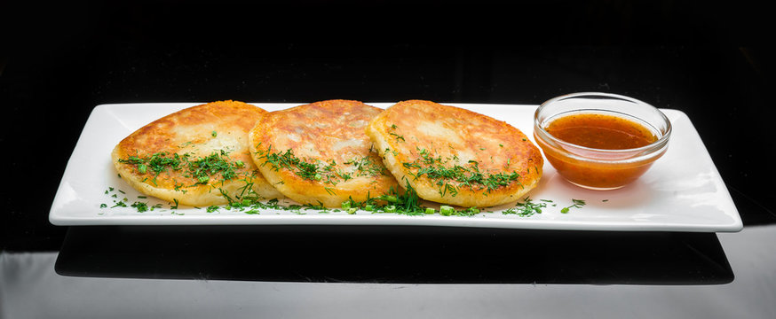 Potato pancake dranik with sauce, Ukrainian dish