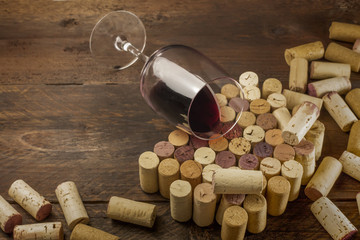 Glass of red wine and corks with place for text