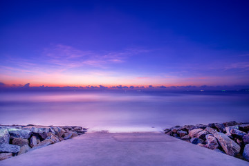 stone pier on the sea at sunrise, Hua Hin Thailand, long exposure sea scape