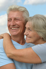 Happy elderly couple embracing