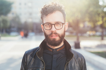 Portrait of young bearded caucasian man outdoor looking camera - customer, serious concept