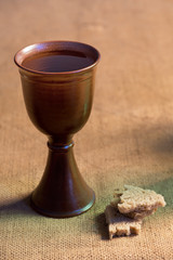 Chalice Of Wine With Bread On The Table