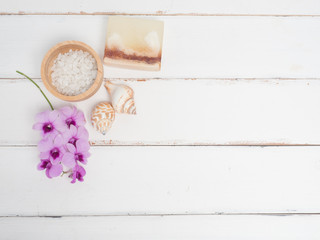 Aromatherapy  product  Spa set ,candle ,soap,coconut orchid flower,shell,  massage  with white wood  background . top view composition.