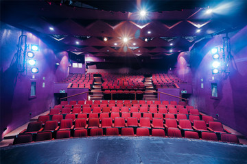 Theater stage and seats with dramatic lighting