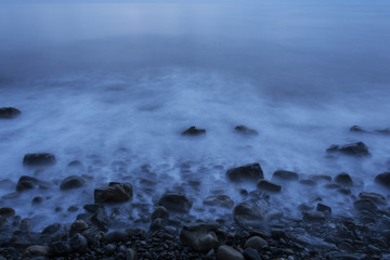 Sea stones on the beach after sunset
