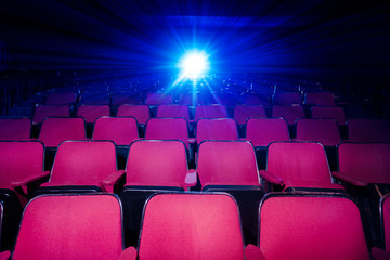 Movie Theater with empty seats and projector. - obrazy, fototapety, plakaty