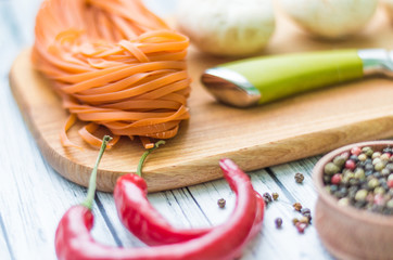 Still life with pasta ingredients on the wooden background