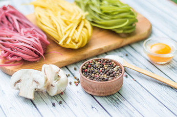 Still life with pasta ingredients on the wooden background