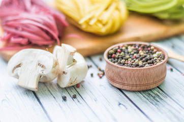 Still life with pasta ingredients on the wooden background