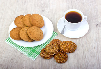 A cup of coffee and assorted cookies on the table.