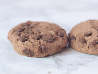 Crisp chocolate cookies on marble background