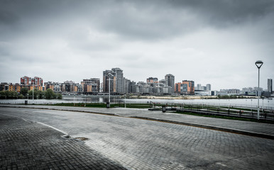 Modern residential buildings on the banks of the river Kazanka. Urban High Contrast Desaturated Look. Cross processed photo