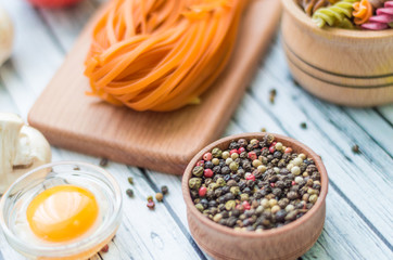 Still life with pasta ingredients on the wooden background