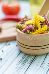 Still life with pasta ingredients on the wooden background