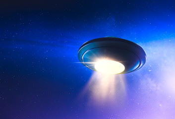 UFO with abduction beam flying in the sky © fergregory